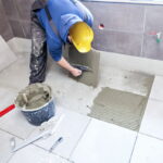 Tiling Floor & Wall. The tiler builder arranges the bathroom cer